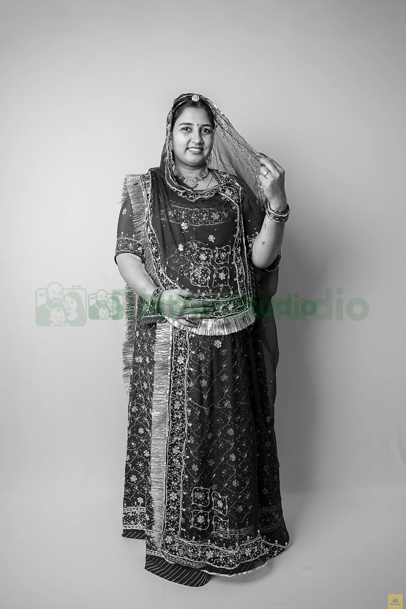 Veiled mother-to-be in an embroidered lehenga, black and white